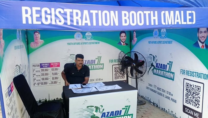 A person sits at the registration desk at the Mega Azadi Marathon organized by the Youth Affairs and Sports Department Punjab. — Facebook/@SportsBoardPunjab/file