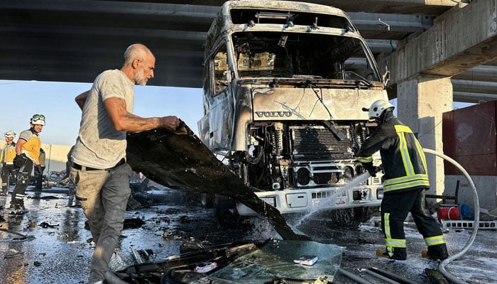 Firefighters extinguish a blaze at the site of a bomb blast at a checkpoint in Syrias Turkish-controlled northern city of Azaz on August 7, 2024. — AFP