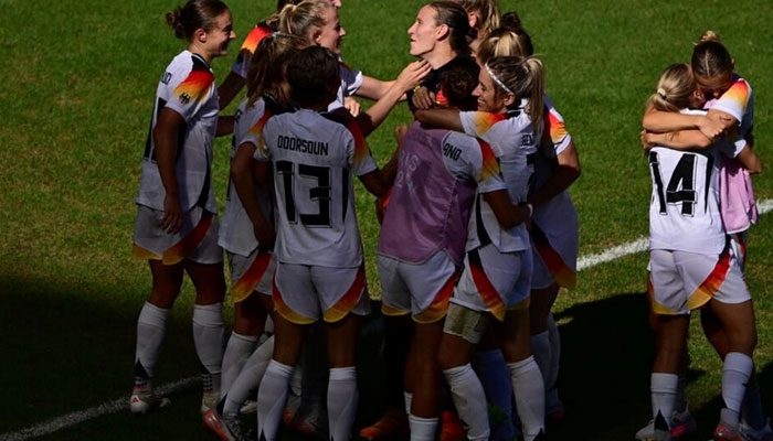 Germany goalkeeper Ann-Katrin Berger is surrounded by teammates after her dramatic last-gasp penalty save against Spain sealed Olympic bronze for her team. — AFP/File