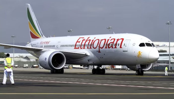 A member of the ground crew directs an Ethiopian Airlines Boeing 787-8 Dreamliner plane at the Bole International Airport in Ethiopias capital Addis Ababa on August 21, 2015. — Reuters
