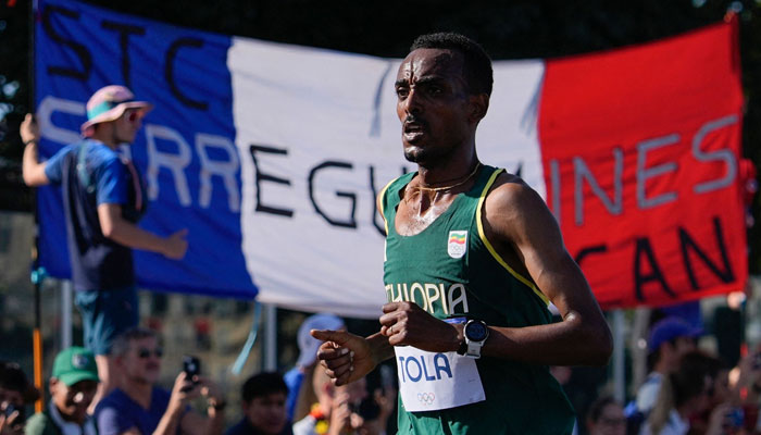 Ethiopias Tamirat Tola competes in the mens marathon of the athletics event at the Paris 2024 Olympic Games in Paris on August 10, 2024. — AFP