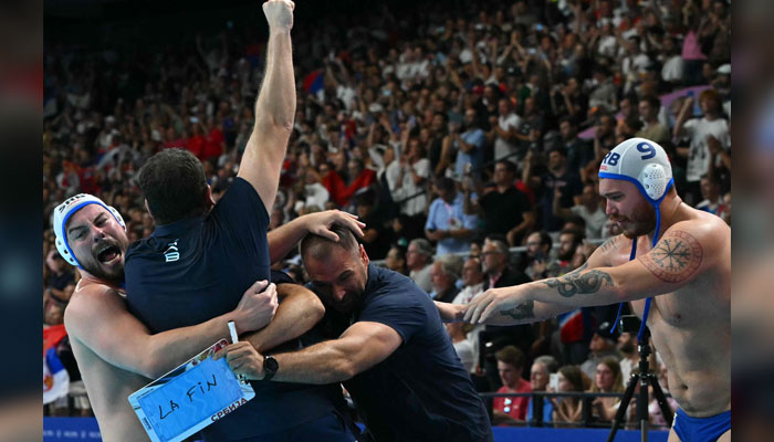 Serbias players celebrate with their coach after winning the mens water polo gold medal match between Serbia and Croatia during the Paris 2024 Olympic Games in Paris on August 11, 2024. — AFP