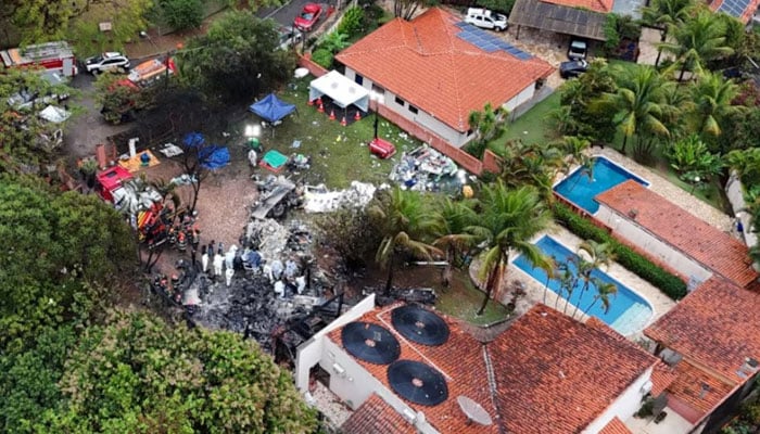 A drone view shows people working at the site of a plane crash in Vinhedo, Sao Paulo, Brazil on August 10, 2024. — Reuters