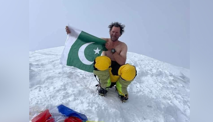 A representational image showing mountaineer Murad Sadpara posing with the national flag in this image released on August 11, 2024. — X/@sadiqsidiqiGB_
