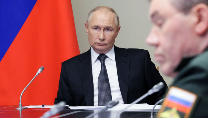 Russias President Vladimir Putin (L) chairs a meeting regarding the situation in the Kursk region, in his residence in Novo-Ogaryovo outside Moscow, on August 12, 2024. — AFP