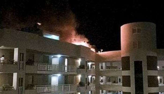 A fire burns at the Double Tree Hotel after a helicopter crashed into the roof in Cairns, Australia on August 12, 2024. — Reuters