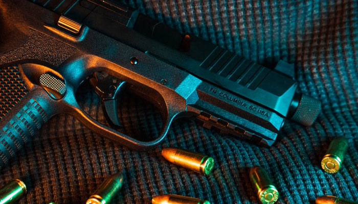 This representational image shows a gun and bullets. — Unsplash