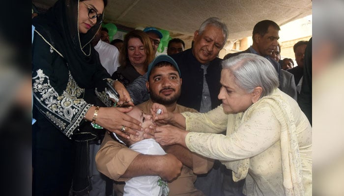 Minister Health Dr Azra Fazal Pechuho (right) administers polio drops to a child at Khalid Jameel Dispensary, Garden East, Karachi, on August 14, 2024. — Facebook/Dr. Azra Fazal Pechuho