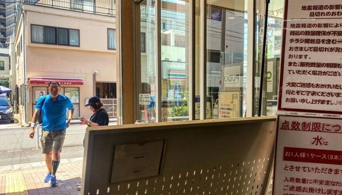 People seen outside a Japanese store. — AFP/file