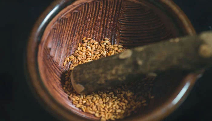 Representational image shows Sesame seeds are being crushed in a bowl. — Unsplash/File