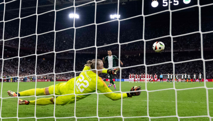 Ajaxs Dutch goalkeeper #22 Remko Pasveer (C) saves a penalty during the penalty shootout at the end of the UEFA Europa League 3rd Qualifying Round second leg football match between Ajax FC and Panathinaikos FC in Amsterdam, on August 15, 2024. — AFP