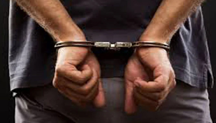 A representational image of a handcuffed man. — APP/File