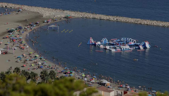 People cool off at the Mediterranean Sea on La Malagueta beach on a hot summer day in Malaga, Spain, July 27, 2024. — Reuters