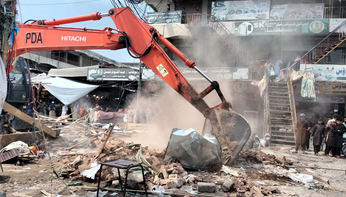 Anti-encroachment operation in progress removed illegal encroachment during anti encroachment drive under the supervision of district administration department, at Karkhano Market in Peshawar on Monday, August 19, 2024. — PPI