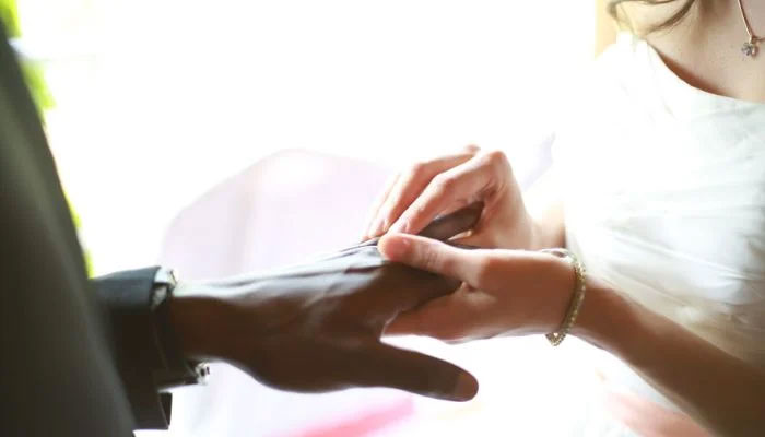 Representational image of a bride depositing the wedding band on the grooms ring finger. — Unsplash/File
