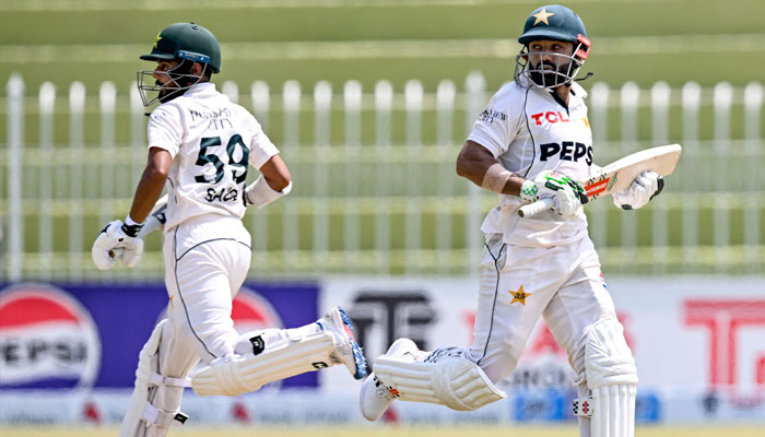 Pakistan´s Mohammad Rizwan (R) and Saud Shakeel run between the wickets during the second day of the first Test cricket match between Pakistan and Bangladesh at the Rawalpindi Cricket Stadium in Rawalpindi on August 22, 2024. — AFP