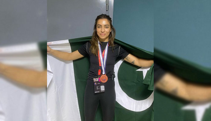 Emaan Khan poses with national flag after winning a gold medal at the Mixed Martial Arts Asian Championship on August 23, 2024.— Instagram@emanfkhan