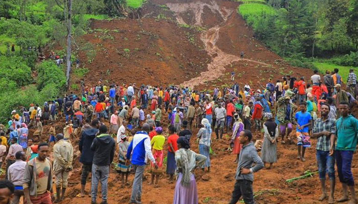 People stands at the bottom of a landslide that occurred in the Geze-Gofa district, Ethiopia. — AFP/File