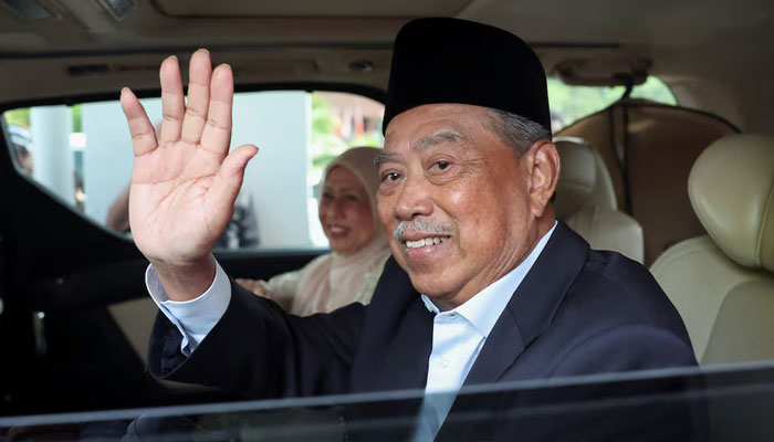 Malaysian opposition leader and former premier Muhyiddin Yassin waves he leaves the Gua Musang Sessions Court in Gua Musang, Malaysia August 27, 2024. — Reuters