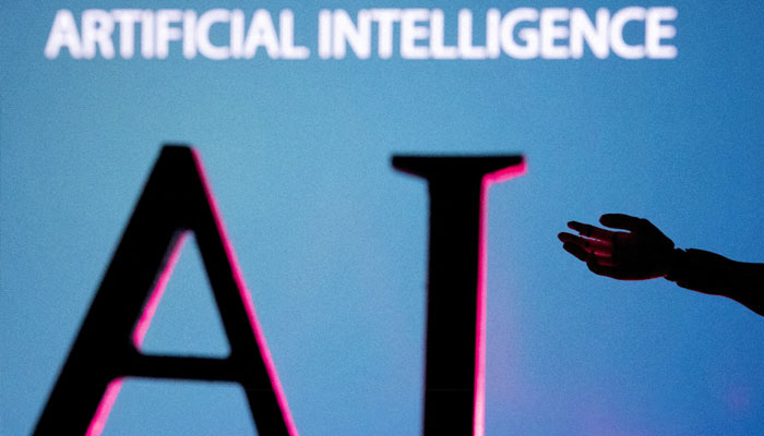 AI (Artificial Intelligence) letters and robot hand miniature in this illustration, taken June 23, 2023. — Reuters