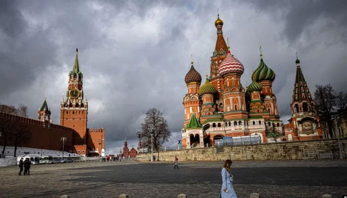 A woman walks near the Kremlin and St. Basils Cathedral in central Moscow, Russia, Feb. 22, 2022. — AFP/file