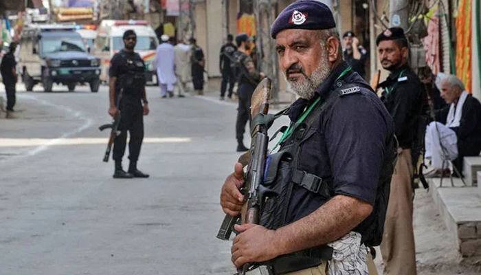 This image shows Peshawar police personnel standing guard on the road. — AFP/File