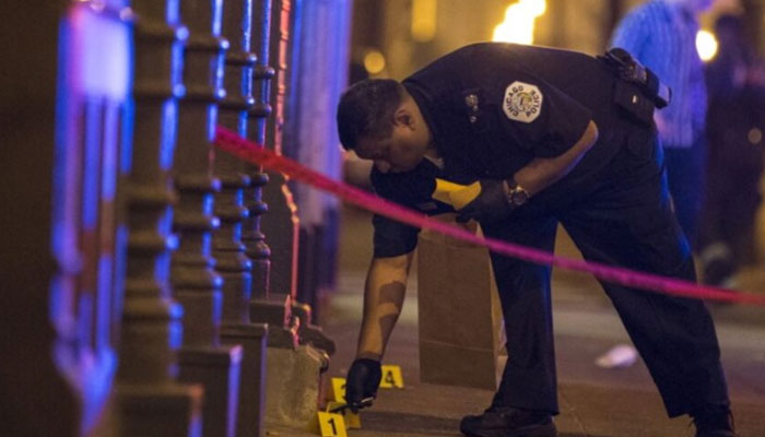 A Chicago police officer collects evidence at a crime scene in Chicago, Illinois, United States on July 5, 2015. — Reuters