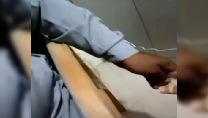 A screengrab showing a police personnel allegedly taking bribes. — YouTube/Geo News/File