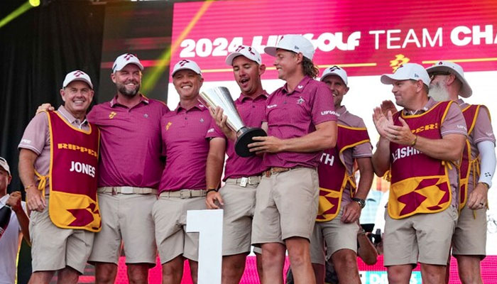Cameron Smith, captain of Ripper GC, holds the LIV Golf team championship trophy as he celebrates with teammates Marc Leishman, Matt Jones, Lucas Herbert and caddies during the LIV Golf Dallas Team Championship Finals at Maridoe Golf Club. — USA TODAY Sport
