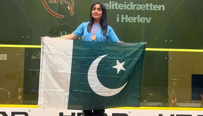Pakistans Mehwish Ali posing with the flag of her country, wearing the gold medal after winning the Nordic Junior Open Squash Championship in Sweden. — Author