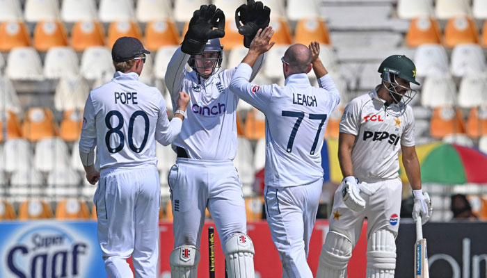 England players celebrate after taking the wicket of Pakistans Salman Agha (R) during the fifth and last day of the first Test cricket match between Pakistan and England at the Multan Cricket Stadium in Multan on October 11, 2024. — AFP