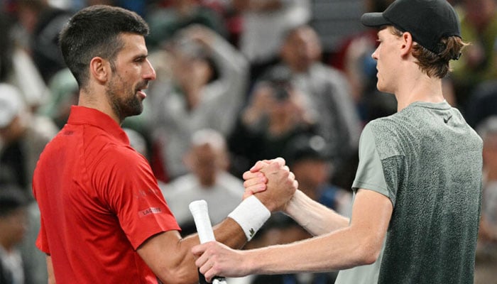 Jannik Sinner (right) is congratulated by Novak Djokovic after winning the Shanghai Masters. — AFP/file
