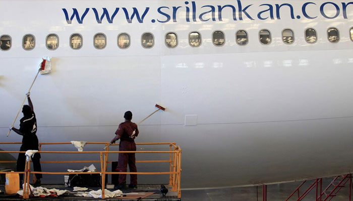 Engineers clean an Airbus 340 at the Sri Lankan Airlines maintenance hangar at the international airport in Katunayake, 30 km (19 miles) north of Colombo, February 10, 2014. — Reuters