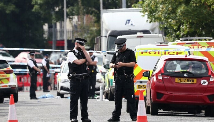 British oolice officers stand guard on Hart Street in Southport, northwest England following a knife attack. — AFP/File