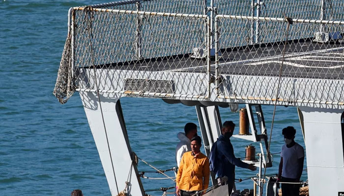 Migrants stand on the Italian navy ship Libra that arrived in Albania as part of a deal with Italy to process thousands of asylum-seekers caught near Italian waters, in Shengjin, Albania, on Oct. 16, 2024. — Reuters