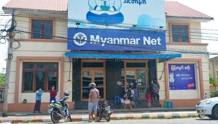 People wait outside an internet shop in Myanmars capital Naypyidaw on March 16, 2021, shortly after a coup. — AFP/File