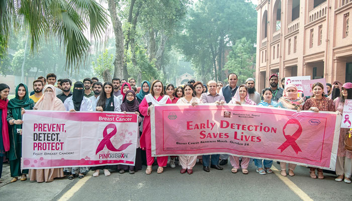 Participants hold banners at an awareness walk on Breast Cancer with the theme of ‘Together we can defeat breast cancer’ in UVAS on October 21, 2024. — Facebook@UVAS.Pakistan