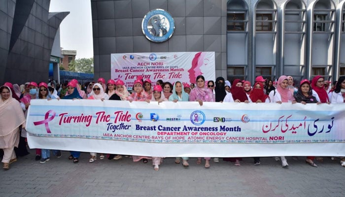 Participants hold banners at the breast cancer awareness walk organised by the Pakistan Atomic Energy Commission (PAEC) on October 22, 2024. — APP