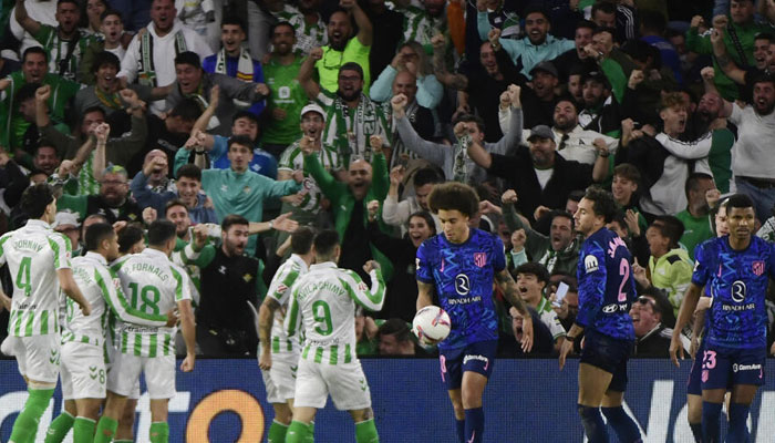 Betis players celebrate an own goal scored by Atletico Madrids Uruguayan defender Jose Gimenez (2nd right). — AFP/File