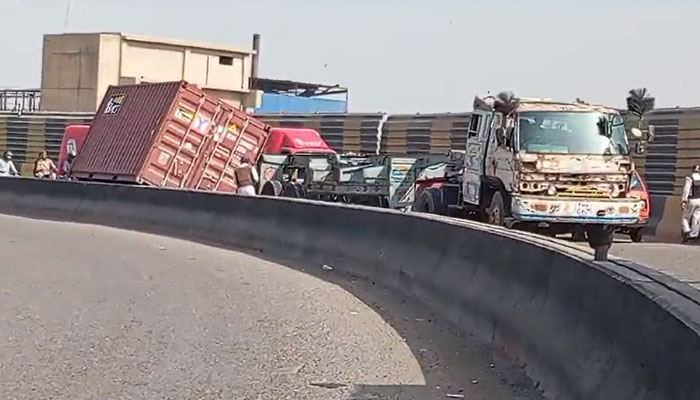 This screengrab taken on October 30, 2024, shows a view of a fallen container on the incident site at the Shershah Bridge area in Karachi. — Geo Tv/Kashif Suri
