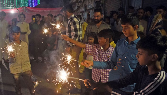 Hindu youngsters light firecrackers during Diwali festival celebrations, in Lahore on November 1, 2024. — Online