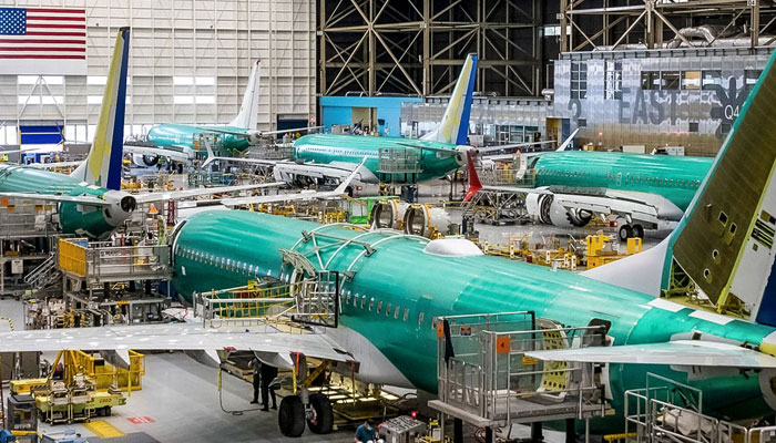 Workers assembling new air crafts in a workshop at Boeing company.— boeing.com/File