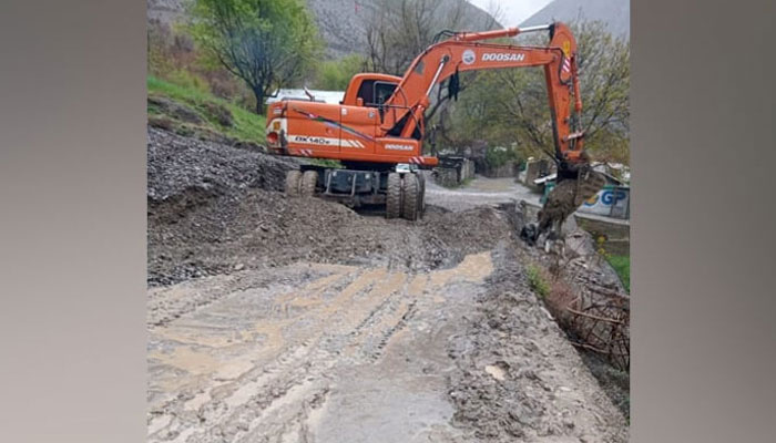 This representational image shows district administrations machinery clearing roads blocked by the landslides and sludge left by the floods on April 14, 2024. — Facebook@DCLowerChitral