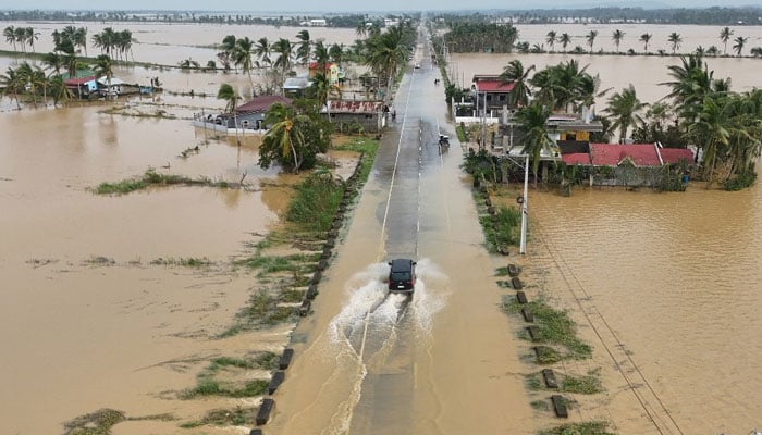 An aerial photo shows flooded houses and rice fields. — AFP/File