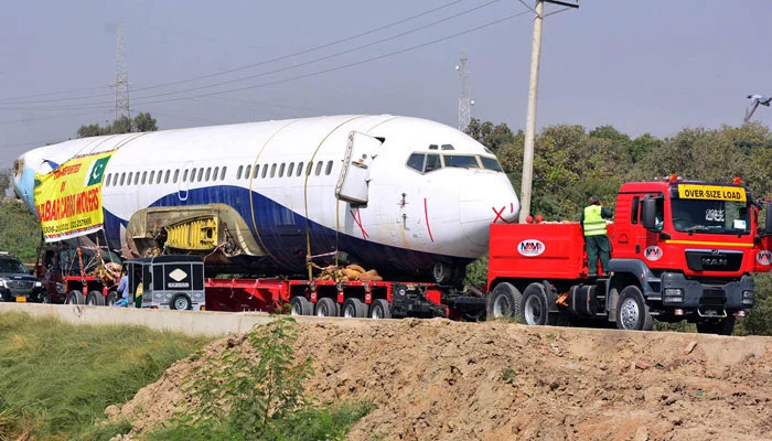 This representational image shows a heavy trailer transporting an aeroplane from Karachi to Hyderabad Airport on October 1, 2024. — APP