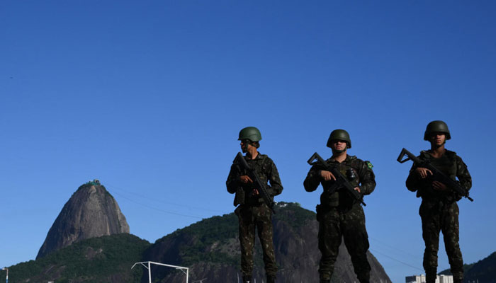 Brazilian army soldiers stand guard on Botafogo beach with the Sugar Loaf mountain in the background during the G20 Summit in Rio de Janeiro. — AFP/File