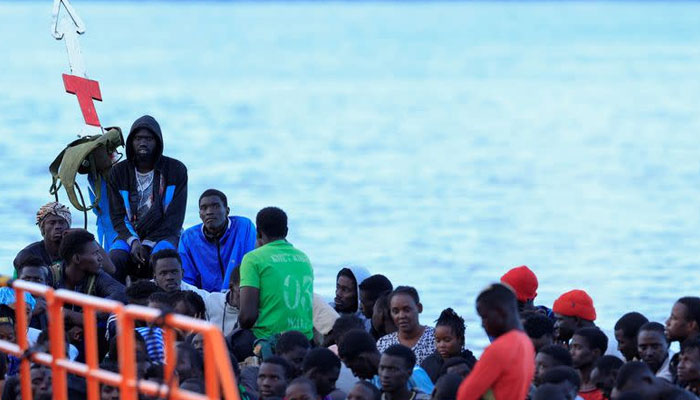 Several migrants wait to disembark from a wooden boat in the port of Arguineguin. — Reuters/File
