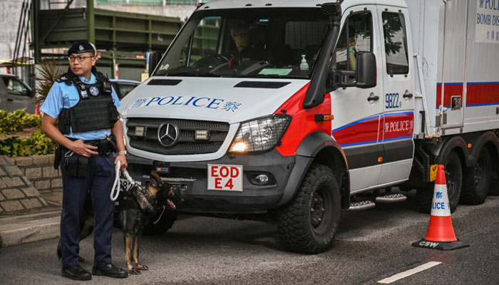 Police keep watch outside the West Kowloon Magistrates Court in Hong Kong during the sentencing of the citys most prominent democracy campaigners. — AFP/file