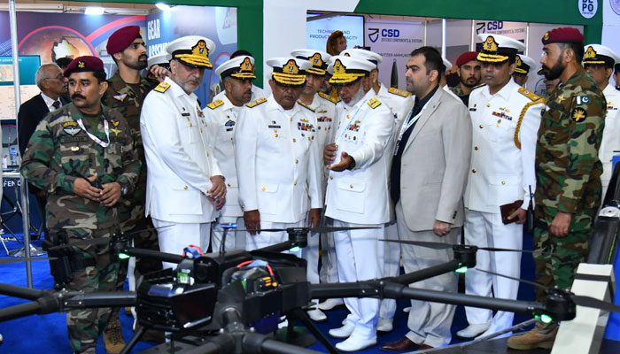 Chief of the Naval Staff Admiral Naveed Ashraf being briefed at a stall during the International Defence Exhibition and Seminar-2024 (IDEAS) on November 21, 2024. — Facebook/@DgprNavy