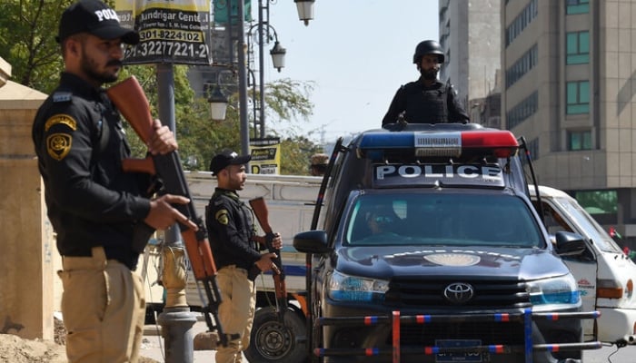 In this file photo, taken on February 8, 2024, policemen stand guard in Karachi. —AFP